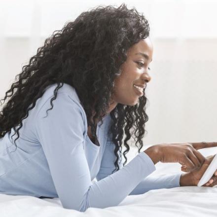 Image of woman reading online newsletter